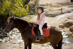 little girl riding a horse with the Cades Cove Riding Stables